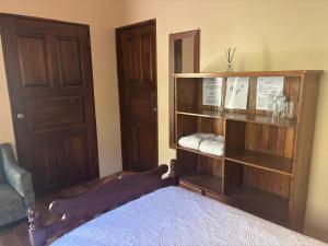 a bedroom with a bed and a book shelf at Jardines del Golfo in Lepanto