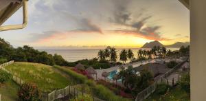 a view of the ocean from a resort at Studio Ti Saphir in Le Diamant