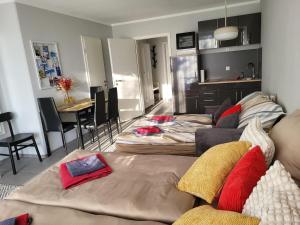 a living room with a couch and a dining room at Bergzauber Bayerwald - voll ausgestattetes Familienapartment mit Pool in Sankt Englmar