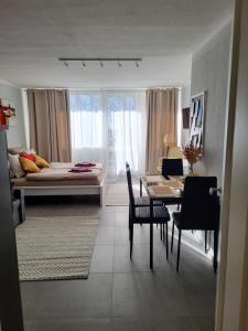 a room with a table and a bed and a dining room at Bergzauber Bayerwald - voll ausgestattetes Familienapartment mit Pool in Sankt Englmar +78 photos