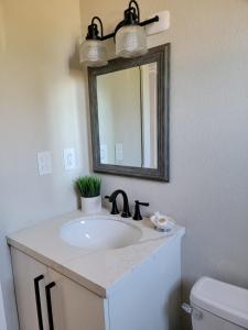 a bathroom with a sink and a mirror at Encuentro Vaquero in Jarabacoa +19 photos