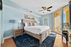 a bedroom with a bed and a ceiling fan at Beach Colony East Unit 1C in Pensacola