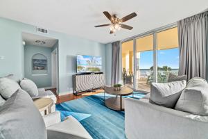 a living room with a couch and a ceiling fan at Beach Colony East Unit 1C in Pensacola +48 photos