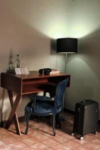a desk with a chair and a lamp and a suitcase at Casa Arrayan in Guadalajara