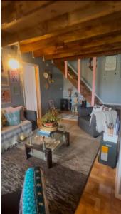 a living room with couches and a coffee table at Casa Arrayán con vista al volcan in Frutillar