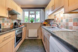 a kitchen with wooden cabinets and a sink at 2 Bed in St. Brides oc-s30491 in Saint Brides