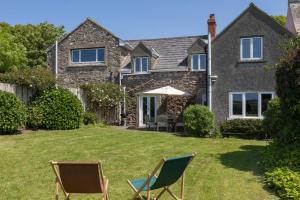 a house with lawn chairs in front of it at 2 Bed in St. Brides oc-k30489 in Saint Brides