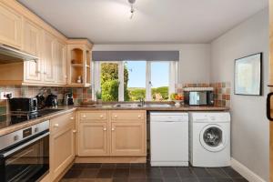 a kitchen with a washer and dryer at 2 Bed in St. Brides oc-k30489 in Saint Brides +15 photos