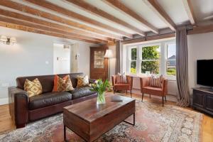a living room with a leather couch and a coffee table at 4 Bed in St. Brides oc-h30490 in Saint Brides