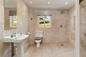 a bathroom with a toilet and a sink and a shower at 4 Bed in St. Brides oc-h30490 in Saint Brides +25 photos