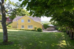 a large yellow house with a patio in the yard at 4 Bed in St. Brides oc-h30490 in Saint Brides