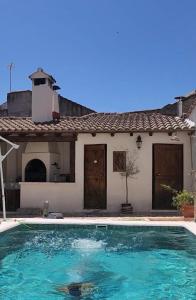 a swimming pool in front of a house at El Corral de Tía Gloria in Pepino