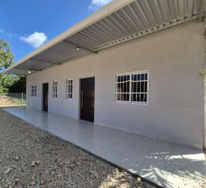 a white building with two doors on the side at Sol in San Benito