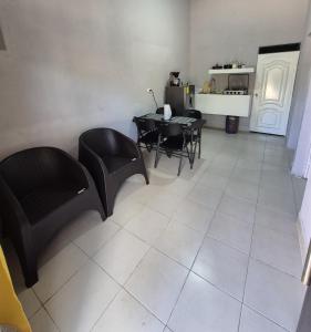 a living room with black chairs and a table at Sol in San Benito