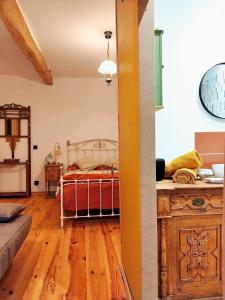 a bedroom with a bed and a wooden floor at Chambre d'hôtes La clef des Champs - LA SOURCE DE NOS RACINES - CORPS DE FERME AU COEUR DU PARC NATUREL DE L'AVESNOIS in Beaufort