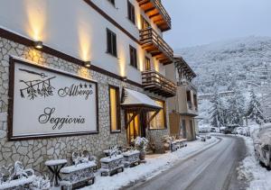 a building with a sign on it in the snow at Albergo Seggiovia in Scanno