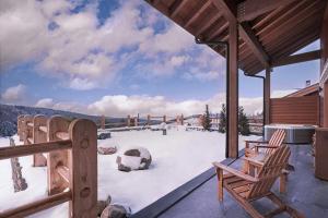 a deck with two chairs and snow on it at Ceylan Splend'or Uludag, Autograph Collection in Uludar