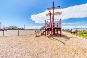 a red playground with a person on a slide at Sea Treasures Inn #206 in Rockaway Beach
