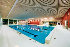 a large swimming pool in a large building at The Golf apartments in Interlaken