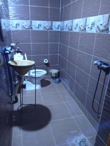 a bathroom with a sink and a toilet at Guesthousefamillytakojt in Merzouga +158 photos