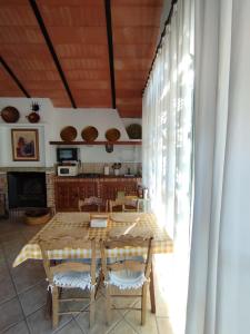 a kitchen with a table and chairs in a room at Casa Rural del Guadalora in Hornachuelos