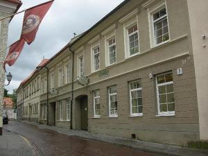 a building with a flag on the side of a street at Litinterp Host in Vilnius