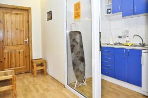 a kitchen with a surfboard leaning against a wall at Litinterp Host in Vilnius