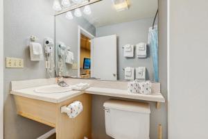 a bathroom with a sink and a mirror at Sea Treasures Inn #207 in Rockaway Beach