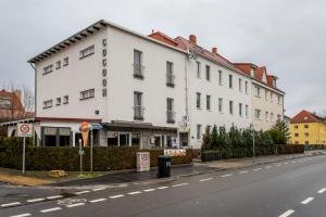 a white building on the side of a street at Conco Leipzig in Leipzig