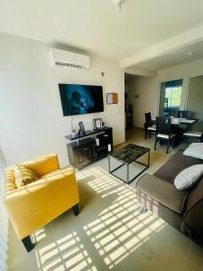 a living room with a couch and a table at Acapulco Vibes - Departamento con Alberca Cerca de Punta Diamante in Acapulco