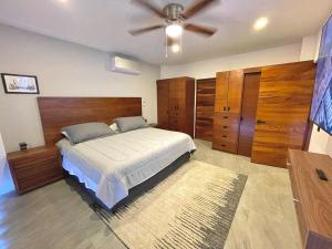 a bedroom with a bed and a ceiling fan at Marea Sabina Luxury Ocean View & Amenities in Cabo San Lucas +20 photos