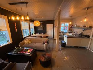 a living room with a couch and a table and a kitchen at Skógafoss in Hvolsvöllur