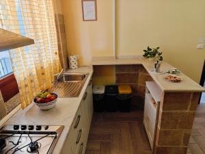 a small kitchen with a sink and a stove at B&B Zio Cici in Minervino di Lecce