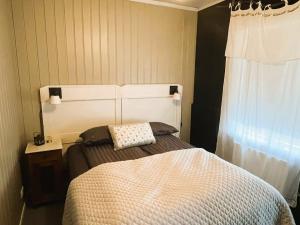 a bedroom with a bed with a pillow on it at Skógafoss in Hvolsvöllur