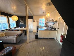 a kitchen and living room with a couch and a table at Skógafoss in Hvolsvöllur +16 photos