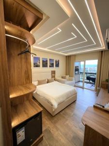 a bedroom with a bed and a tv in a room at Chic studio with balcony, quiet & bright in Tétouan