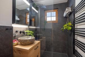 a bathroom with a sink and a mirror at Chalet Valentina in Chateau-d'Oex