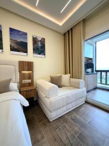a living room with a couch and a bed at Chic studio with balcony, quiet & bright in Tétouan