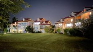 a large yard in front of some buildings at night at Cauris Lodge du Marisol vue mer accès direct plage avec citerne d eau in Le Gosier