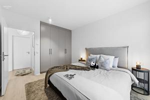 a bedroom with a large bed with a stuffed animal on it at Premium Ice Apartments Atlantic Ocean Magic View in Reykjavík