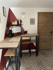 a kitchen with two tables and a door at Chez Marie et Angel in Autun