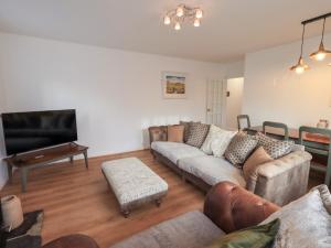 a living room with a couch and a flat screen tv at Glen Lea in Settle