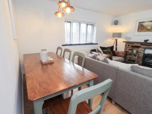 a living room with a wooden table and a couch at Glen Lea in Settle