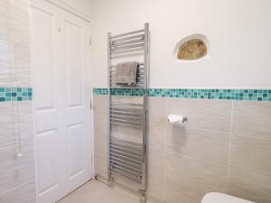 a white bathroom with a shower and a toilet at Glen Lea in Settle +25 photos