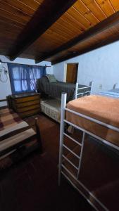 a bedroom with two bunk beds in a room at Casa Refugio in Paso de la Patria