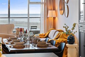 a dining room with a table and a couch at Premium Ice Apartments Atlantic Ocean Magic View in Reykjavík
