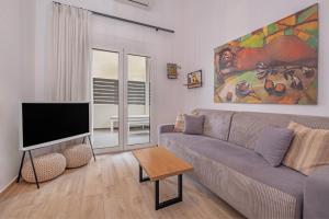 a living room with a couch and a flat screen tv at Rhodes center Santa Mari in Rhodes Town