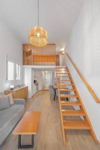 a living room and kitchen with a staircase in a house at Rhodes center Santa Mari in Rhodes Town +1 photo