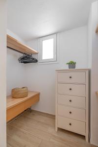 a bedroom with a chest of drawers and a window at Rhodes center Santa Mari in Rhodes Town