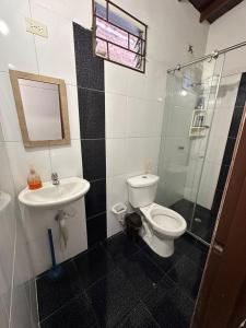 a bathroom with a toilet and a sink and a shower at Hostel Urban City Medellin in Medellín +37 photos